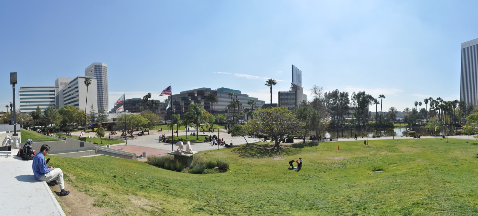 Open lawn, palm trees, and museum buildings at Hancock Park near the La Brea Tar Pits