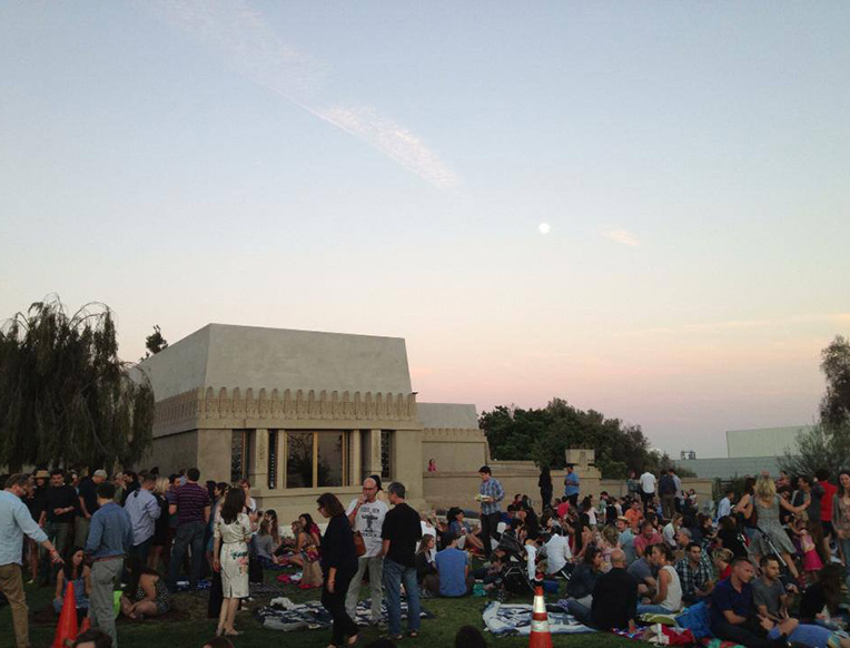 People gathering on the lawn at Barnsdall Art Park at sunset