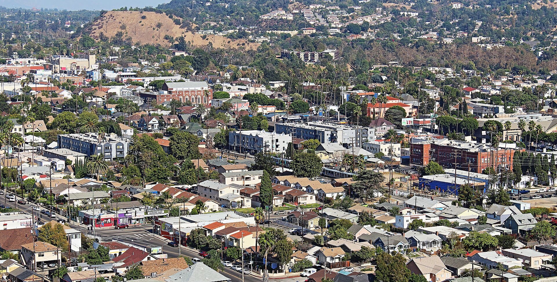 Highland Park homes, historic commercial blocks, and hills seen from above