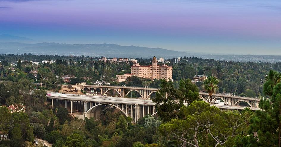 The historic Colorado Street Bridge crossing the green Arroyo Seco in Pasadena