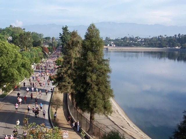 A community run moving along the path beside Silver Lake Reservoir