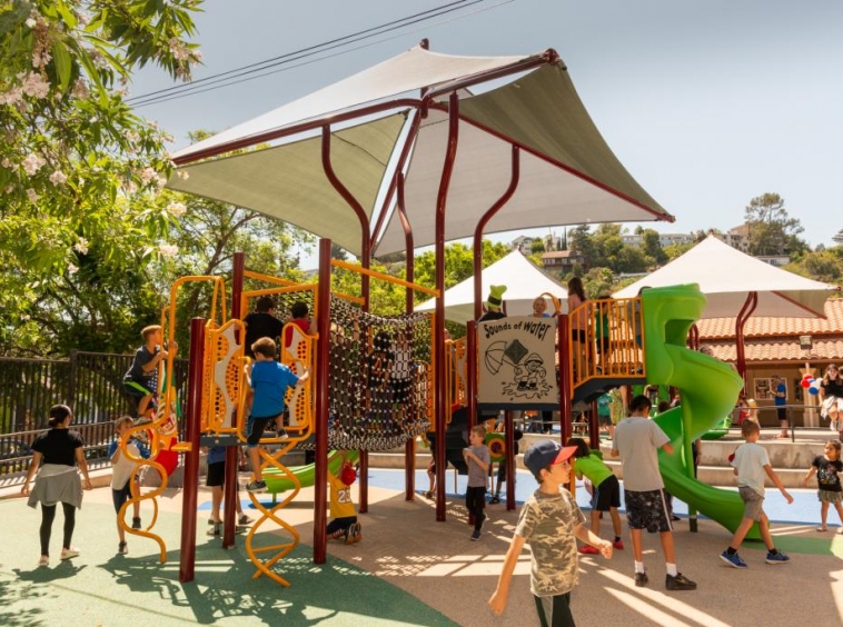 Children playing beneath the shade canopy at Silver Lake Recreation Center