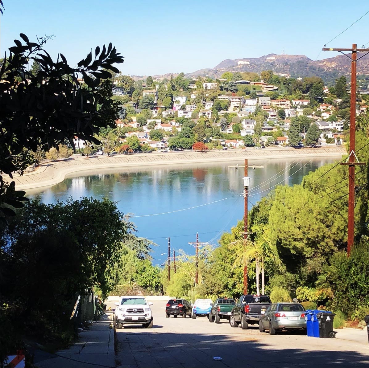 Silver Lake Reservoir and hillside homes with Griffith Observatory and the Hollywood Sign in the distance
