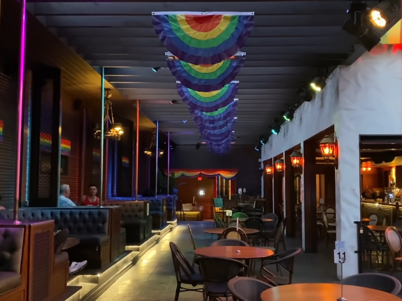 Tables, colorful lighting, and Pride decorations inside The Abbey in West Hollywood