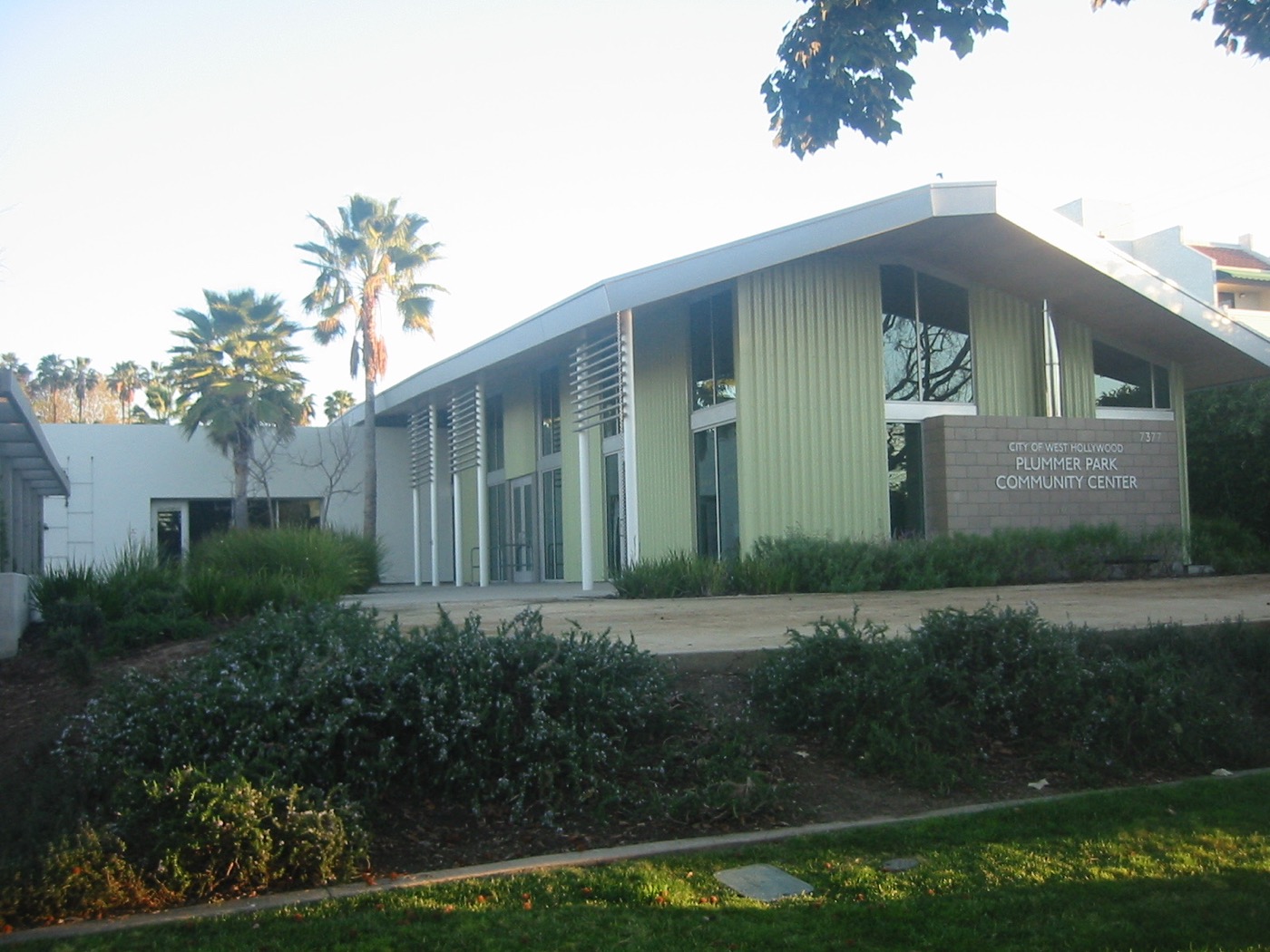 Plummer Park Community Center among lawn, palms, and mature trees in West Hollywood