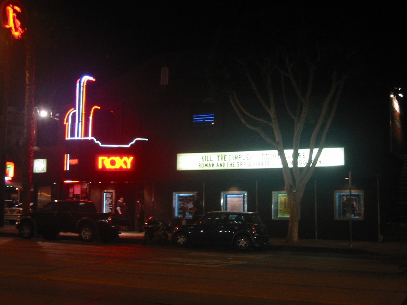 The Roxy Theatre neon sign and marquee glowing at night on Sunset Boulevard