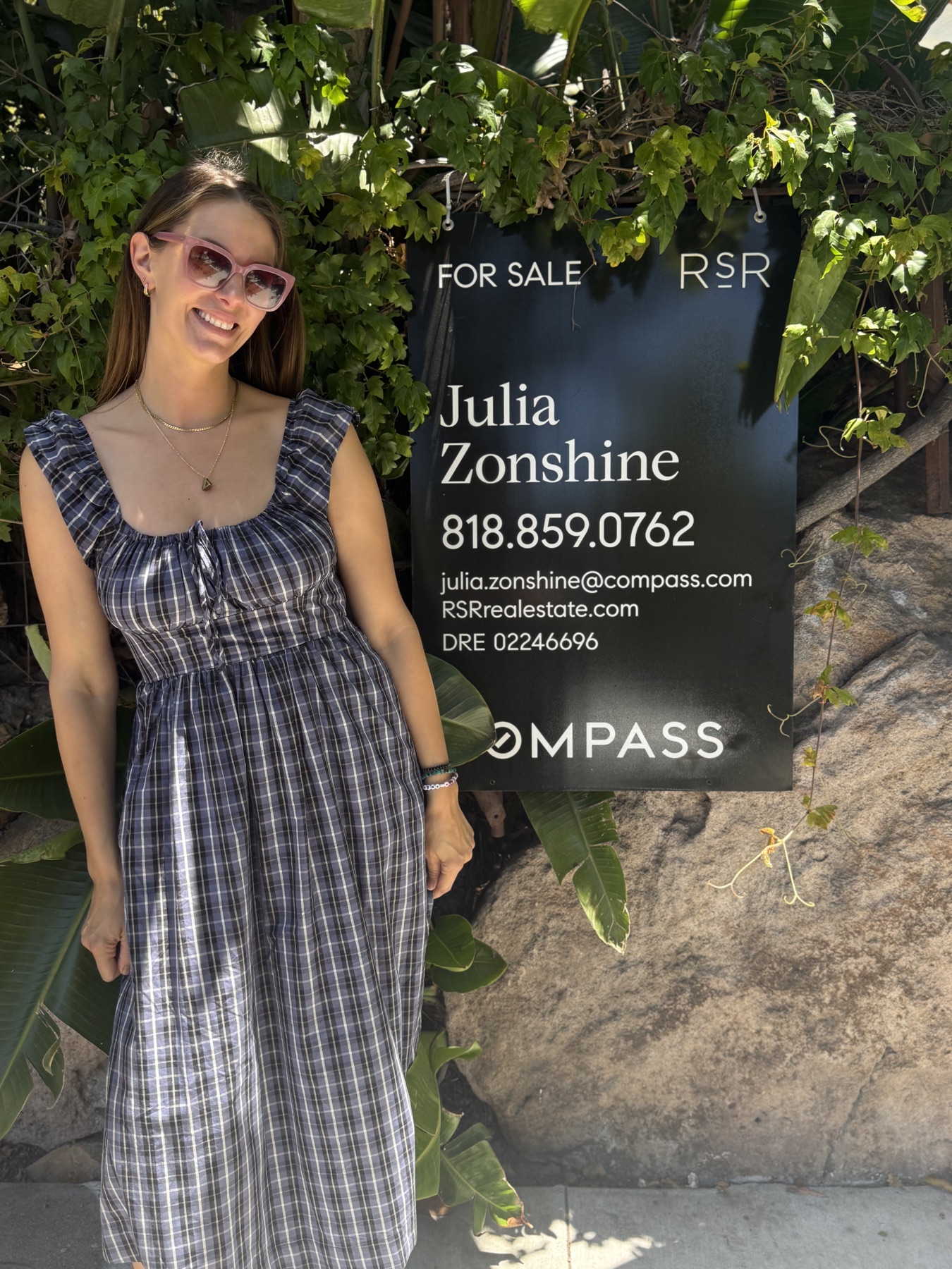 Julia Zonshine beside her for-sale sign