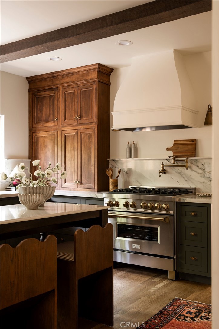 Craftsman kitchen with solid wood cabinetry, exposed beams, and antique brass hardware