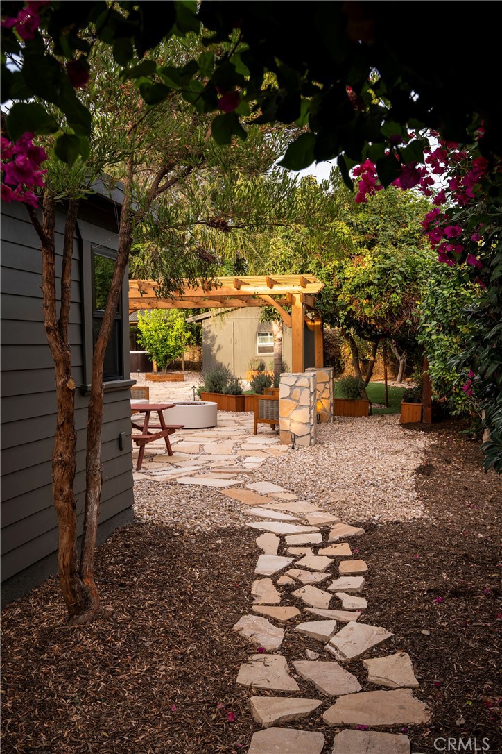 Stone garden path beneath bougainvillea at 1190 N Wilson Avenue