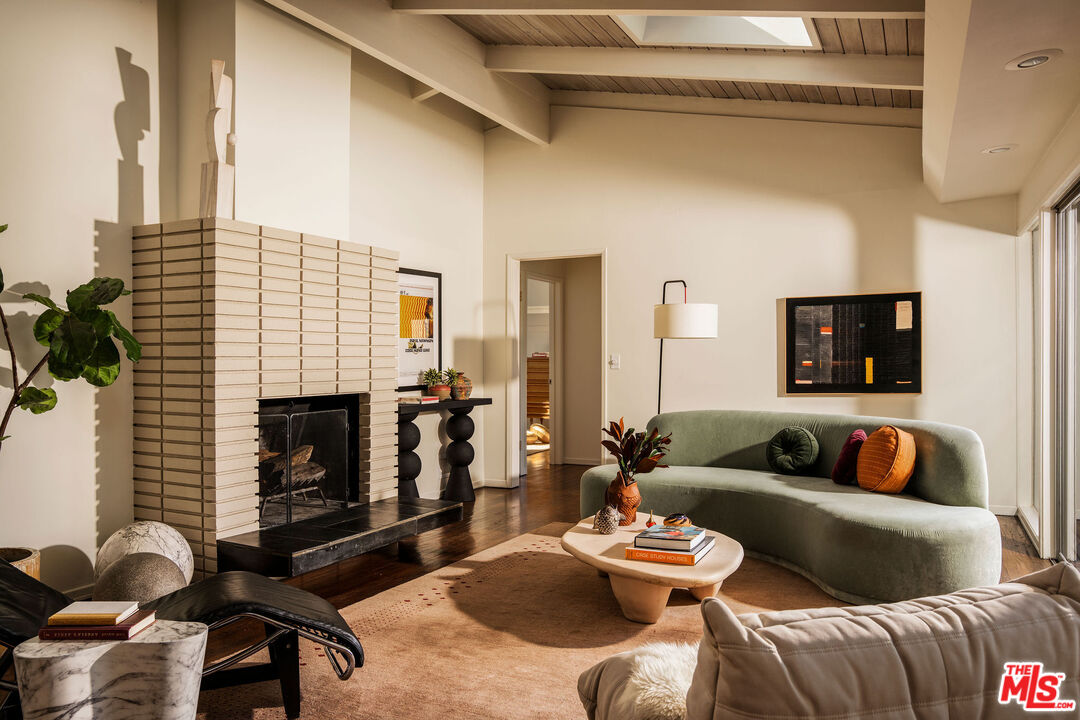 Sunlit living room with original beams at 1200 Olancha Drive in Mount Washington
