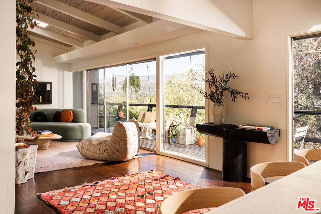 Living area opening through glass doors to a view deck at 1200 Olancha Drive