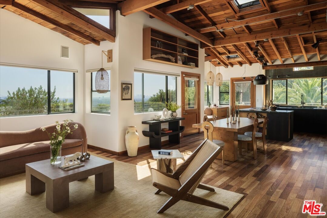 Vaulted wood-beamed living and dining space at 1811 Micheltorena Street in Silver Lake