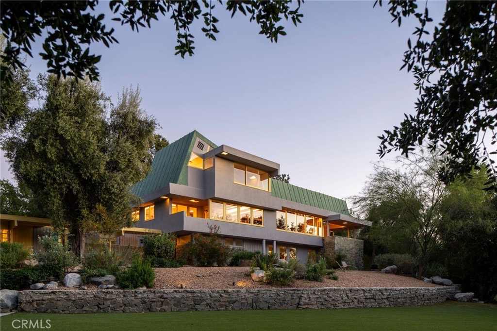 Twilight view of the angled green roofline at 19950 Collier St in Woodland Hills