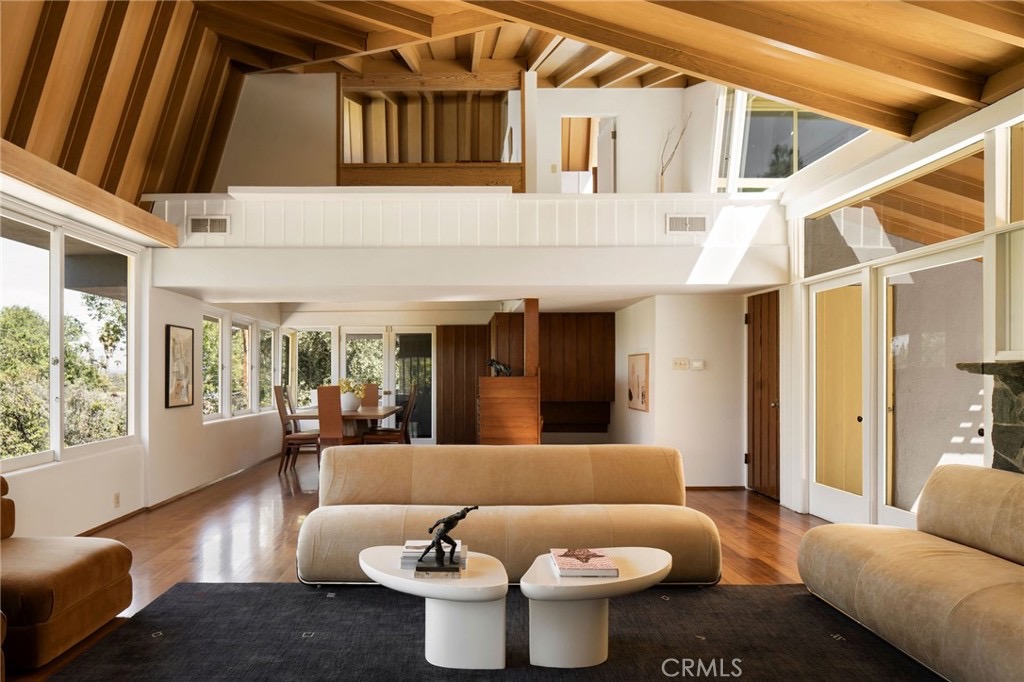 Double-height loft volume with wood beams and clerestory windows inside the Van Dekker House