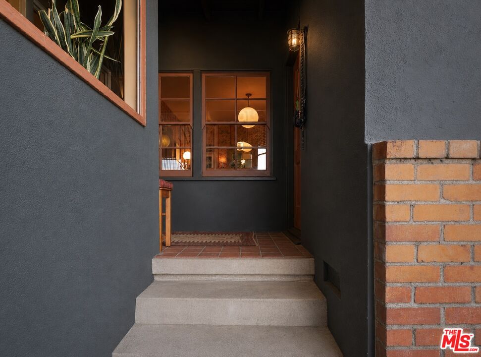Layered living space with books, art, and collected furnishings at 232 La Follette Dr