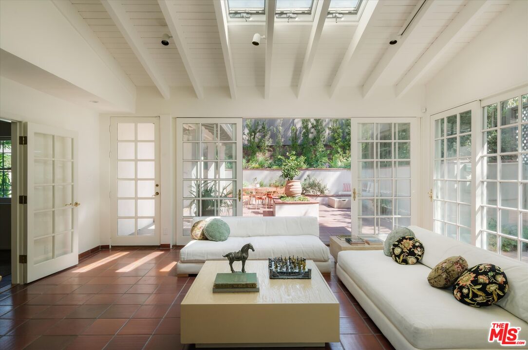 Skylit sunroom with French doors opening to a patio at 2560 Micheltorena Street in Silver Lake