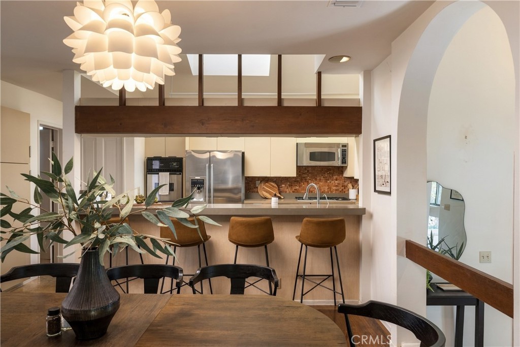 Wood-beamed kitchen and dining area at 3585 Military