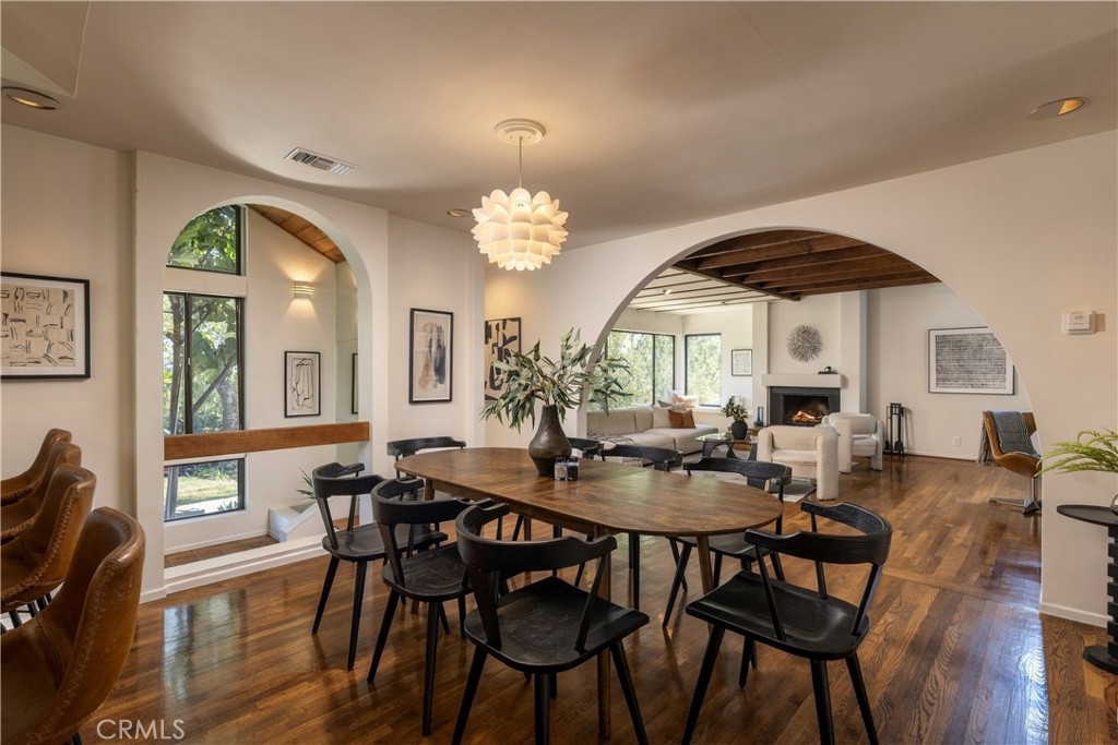 Dining room and living room connected by broad arches at 3585 Military