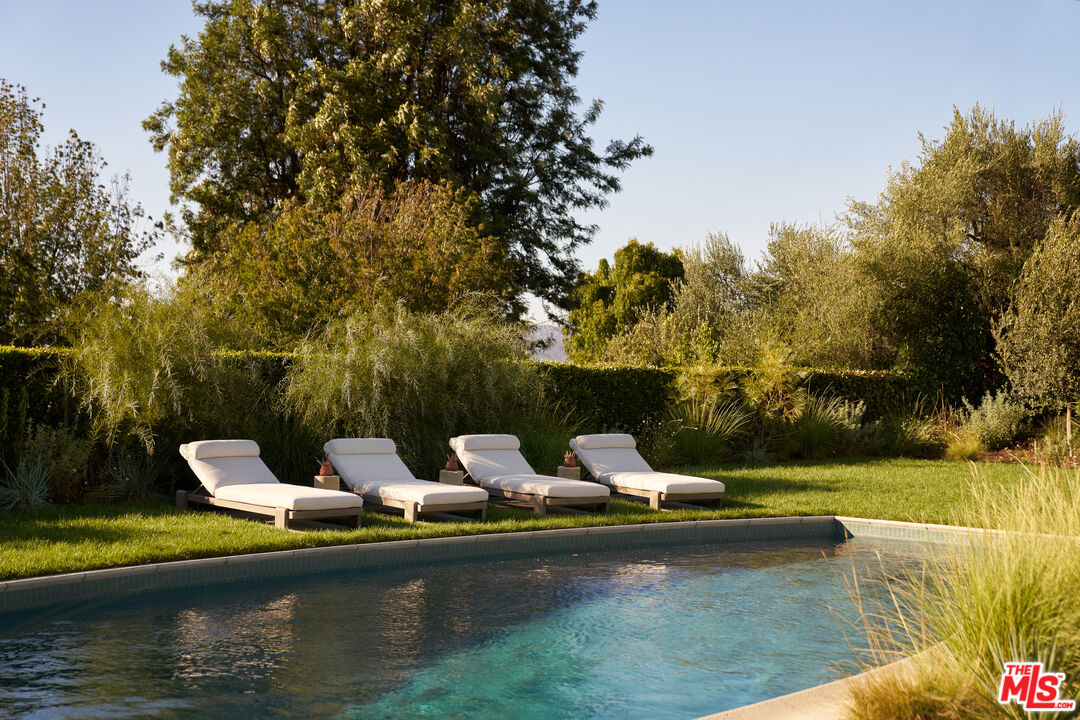 Pool surrounded by layered landscaping at 4301 Manson Avenue