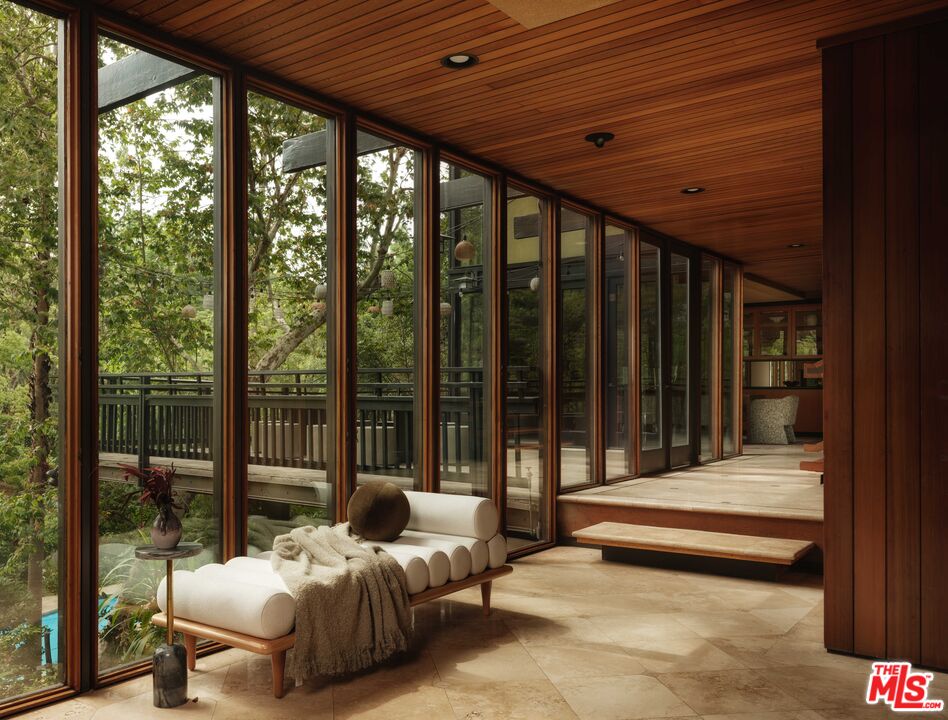 Glass-lined redwood corridor looking into the trees at 954 Hillside Terrace